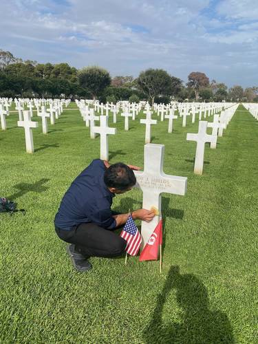 The cemetery groundskeeper prepares the grave for our visit.