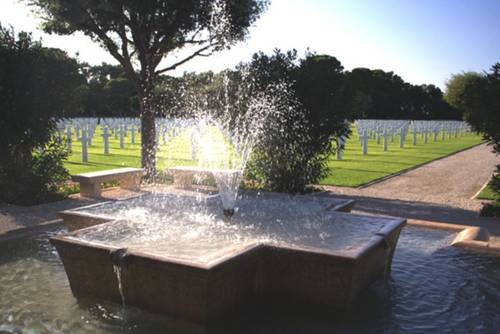 The cemetery’s beautifully manicured grounds, interspersed with cooling fountains, is a small oasis in the fierce Tunisian heat. The spray of the fountains points directly toward the white marble headstones and the memorial chapel.