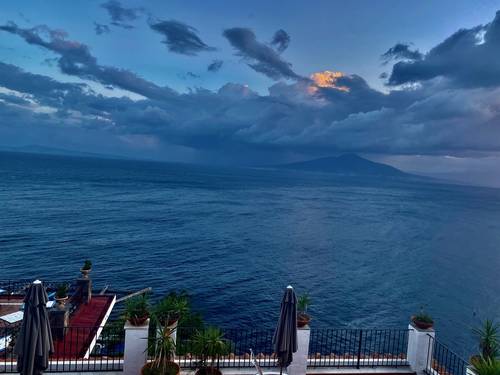 Mt. Vesuvius on the left.  Pompeii below the peak. Naples in the distance, in the midst of a rain storm.