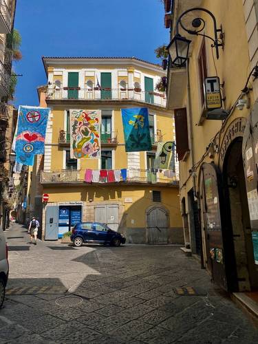 #10 Lots of colorful banners hanging throughout the older section of town, uphill from the more modern streets below -- from a recent festival, or community celebration?