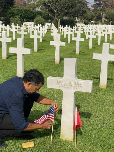 When a visitor asked to see a particular grave, this man would carefully rub wet sand into the engraved/recessed name so it would become more visible.