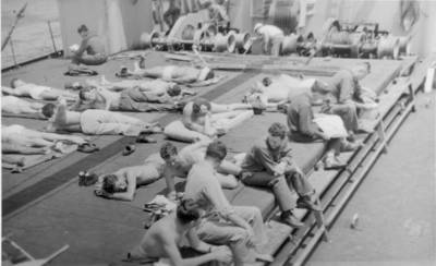 "The men are quartered and fed much better than on the “tub” that we came over on originally. [from the U.S. to Northern Ireland] This ship is about the same size, but is much cleaner in every way. It’s actually a re-outfitted luxury cruise ship, which suits us fine. The men are enjoying some deck time in the sunshine."