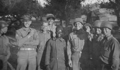 "August 1943: "A French Senegalese soldier that wandered into our area one day up near Gertie's place. [Bizerte?] He said he had five wives and was allowed seven if he could provide for them. He had the widest grin you've ever seen and he grinned all the time. He certainly did spruce up when he found he was going to have his picture taken."