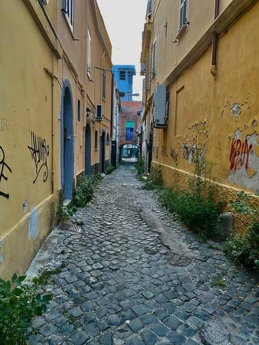 Down this long narrow cobblestone street, we came upon a large locked wooden door.  Silvano had the key.