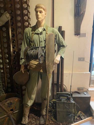 A communications specialist with his spool of wire to lay down from the the frontlines back to the command post.