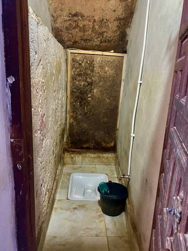 A home's shower in the Casbah. No running water, so bathing is done with buckets of water.