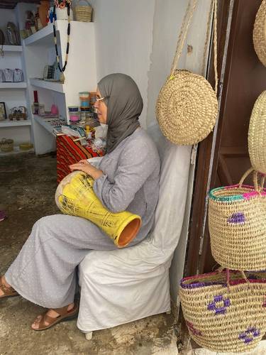 A Casbah merchant plays her drums for us.